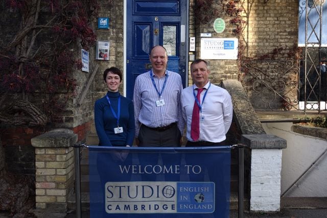 Academic managers at Studio Cambridge posing in front of Main School steps on Station Road