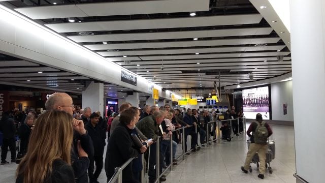Studio Cambridge representatives wait for new English students to arrive in Heathrow Terminal 2