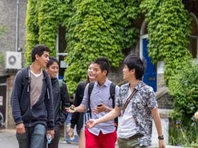 An image of students on a General English course in Cambridge, standing outside Studio Cambridge Main School. The image links to a page on the EFL-20 course.