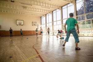 Students taking part in athletics activity in sports hall at Sir Henry residential English summer camp, based in Hockerill College