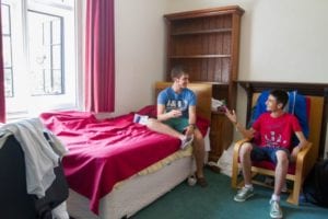 Two international students chat in single bedroom at Sir Christopher residential English summer camp