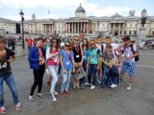 Group of students pose for picture in front of Trafalgar Square, London, on an excursion at Sir Richard residential English summer camp