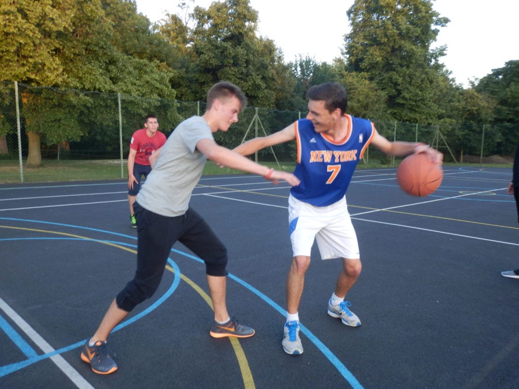 Students play basketball at a Studio Cambridge summer camp.