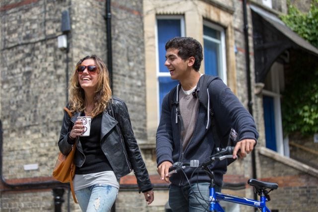 Two English language students outside Studio Cambridge Main School on Station Road, Cambridge