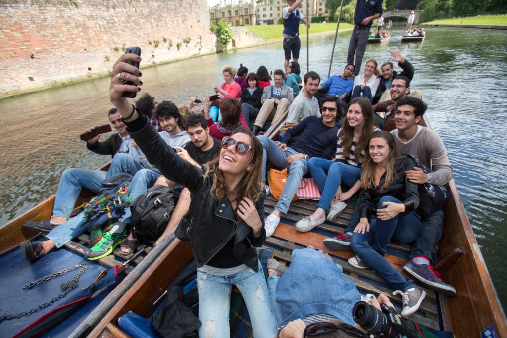 Students take a selfie on a punt in Cambridge on the River Cam.