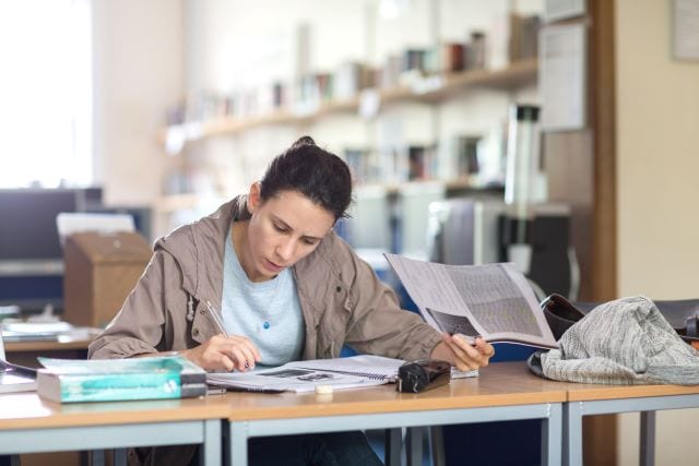 Student revising for English language exam in Learning Centre at Studio Cambridge