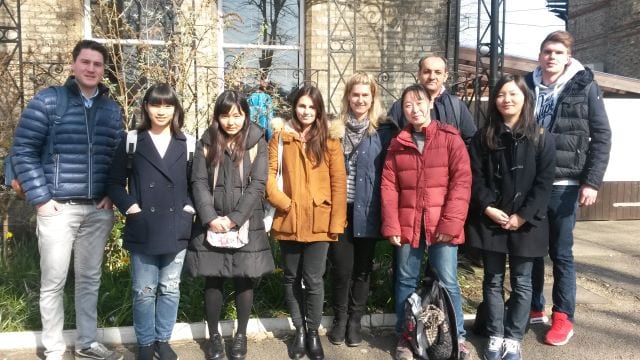 Adult students in group outside Studio Cambridge English language school