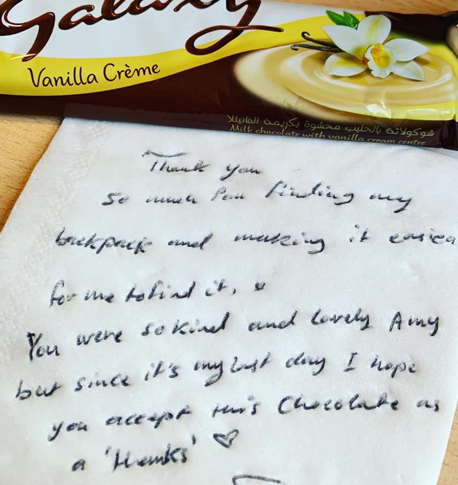 A handwritten note underneath a bar of Galaxy Vanilla Creme chocolate, reading, 'Thank you so much for finding my backpack and making it easier for me to find it. You were so kind and lovely Amy but since it's my last day I hope you accept this chocolate as a 'thanks' [doodle of heart]'. 