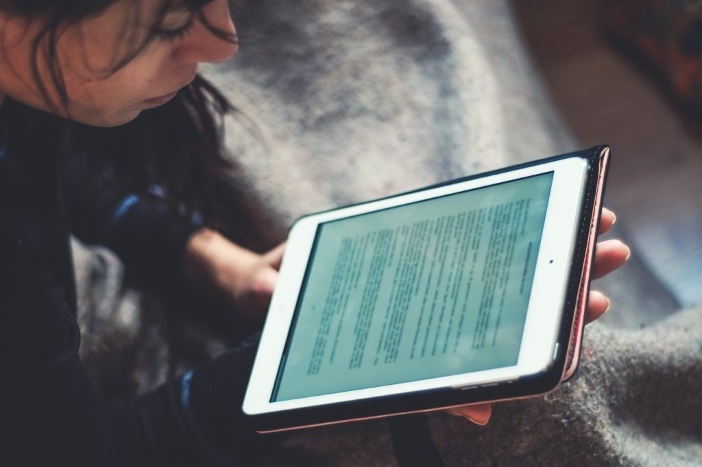 Close-up of person reading tablet