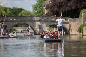 A group of students punting on the River Cam